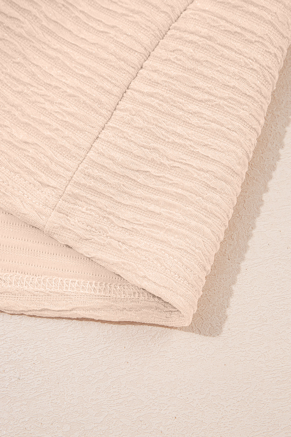 Warm tones, cool vibes. This textured V-neck tee and shorts set in a soft apricot is the matching set made for summe