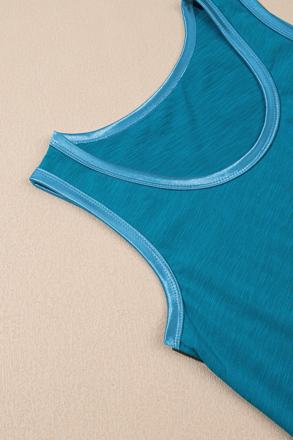 Bold color, subtle shine. This scoop neck tank in a rich peacock blue features a gleaming metallic sheen edge that catches the light in all the right ways