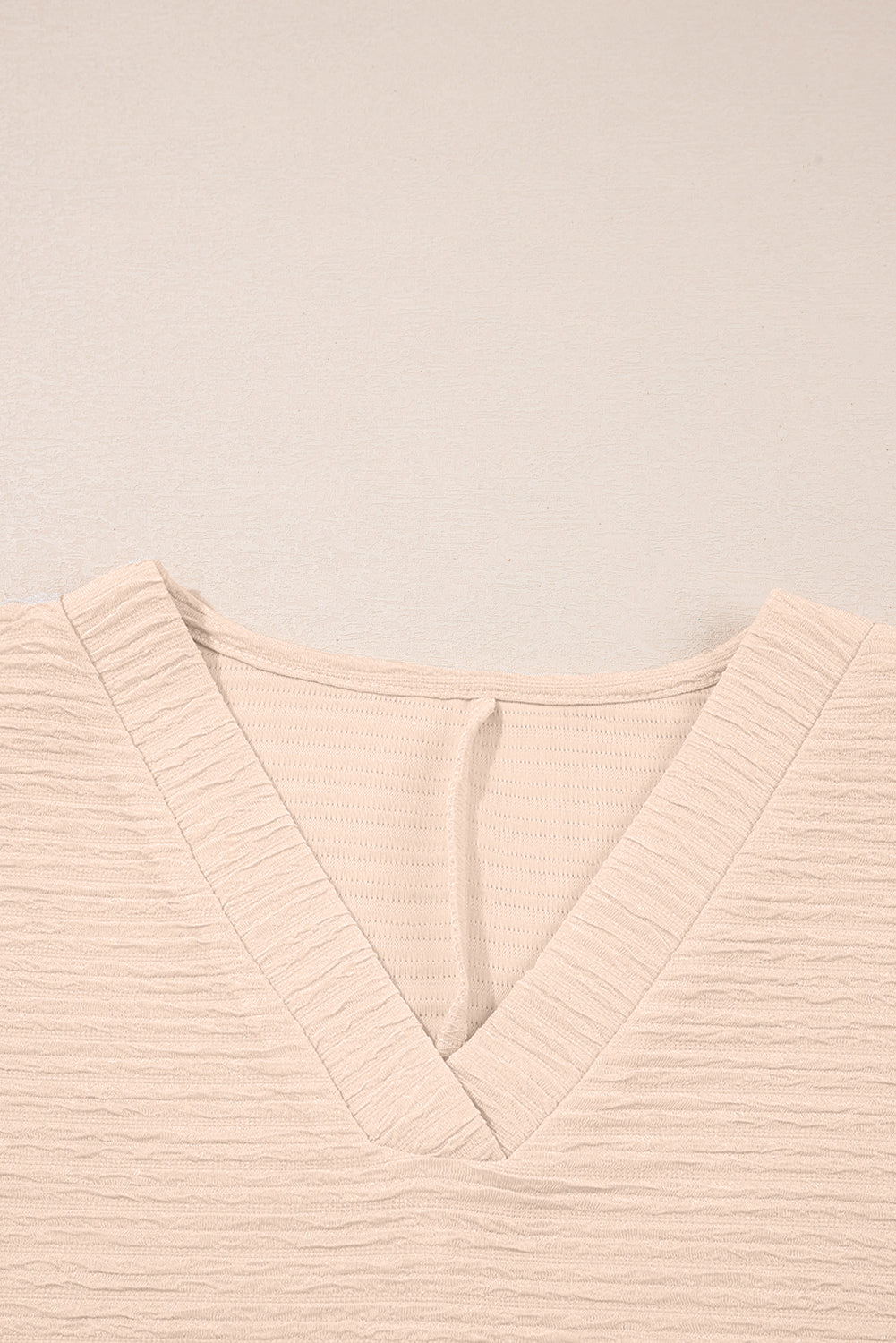 Warm tones, cool vibes. This textured V-neck tee and shorts set in a soft apricot is the matching set made for summe