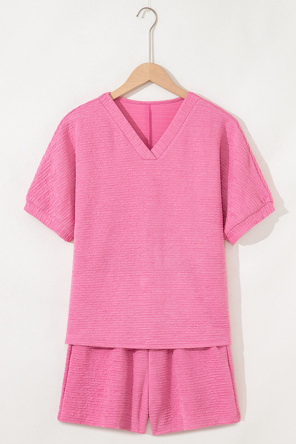 Easy, breezy, and totally put-together. This textured V-neck tee and shorts set in a soft pink is the matching set you'll want to live in all summer