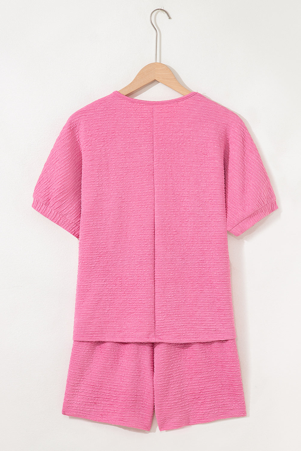 Easy, breezy, and totally put-together. This textured V-neck tee and shorts set in a soft pink is the matching set you'll want to live in all summer