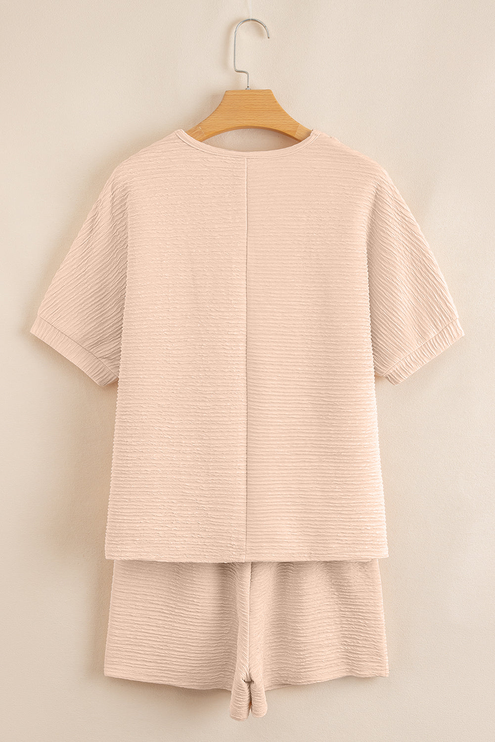 Warm tones, cool vibes. This textured V-neck tee and shorts set in a soft apricot is the matching set made for summe