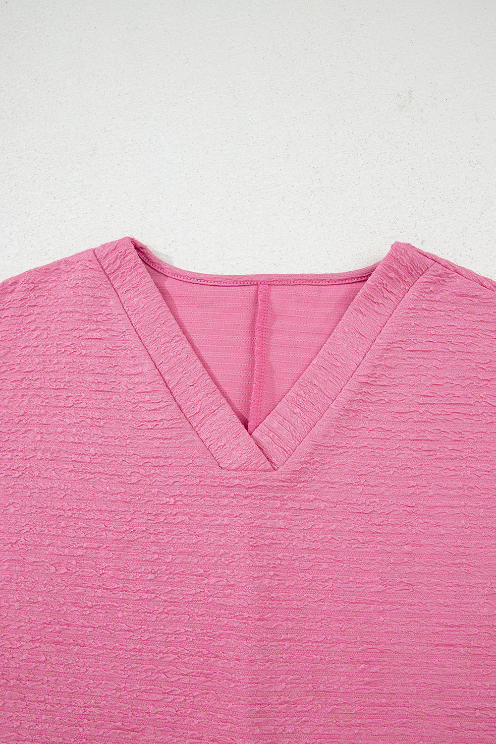 Easy, breezy, and totally put-together. This textured V-neck tee and shorts set in a soft pink is the matching set you'll want to live in all summer