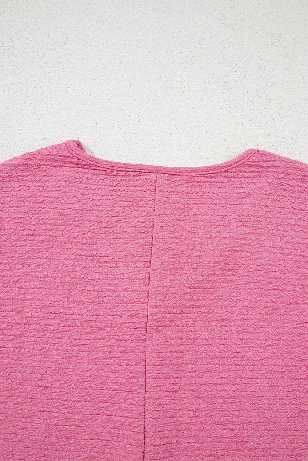 Easy, breezy, and totally put-together. This textured V-neck tee and shorts set in a soft pink is the matching set you'll want to live in all summer