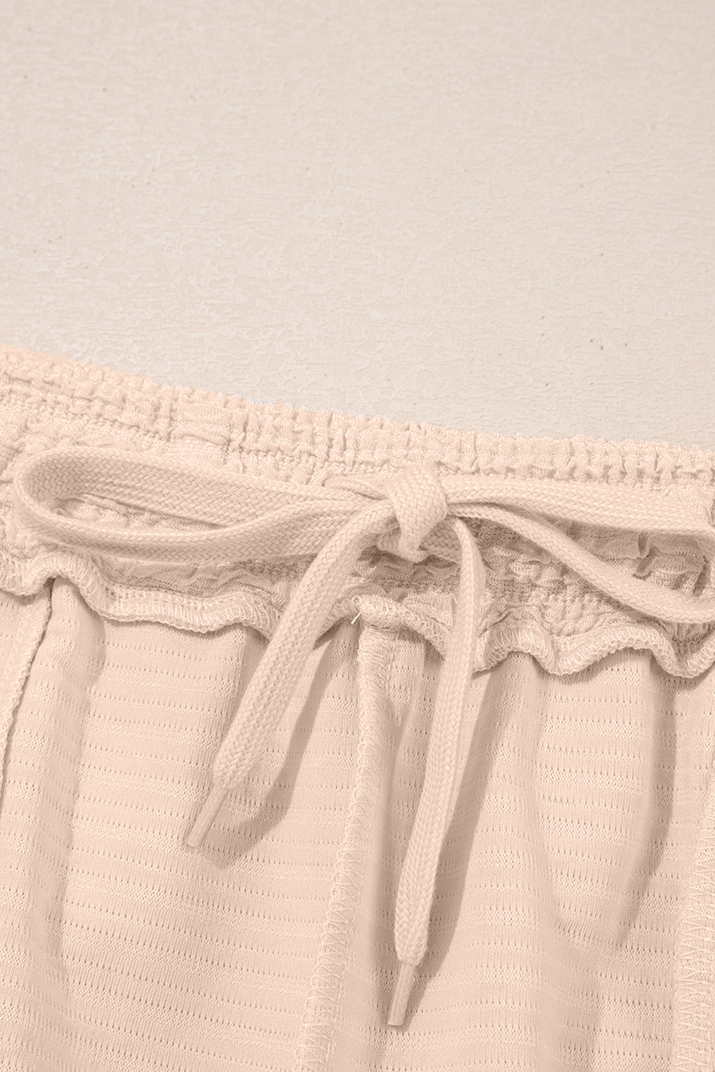 Warm tones, cool vibes. This textured V-neck tee and shorts set in a soft apricot is the matching set made for summe
